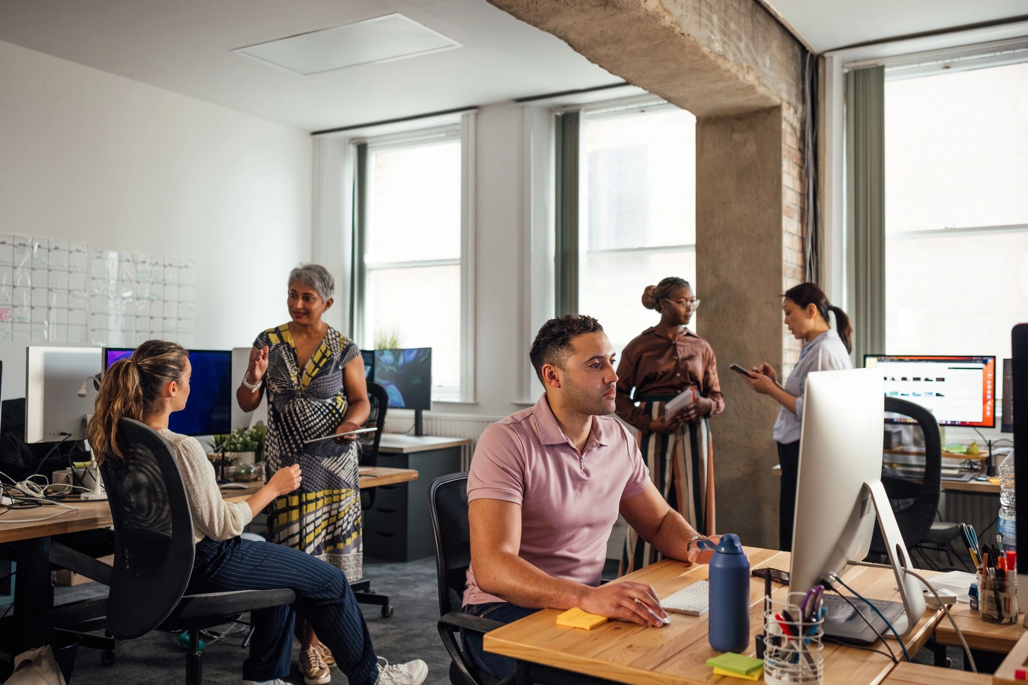 IT services team collaborating in a modern office