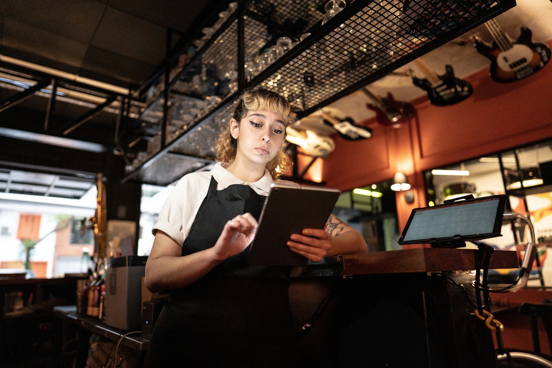 Restaurant staff member using a tablet for operations
