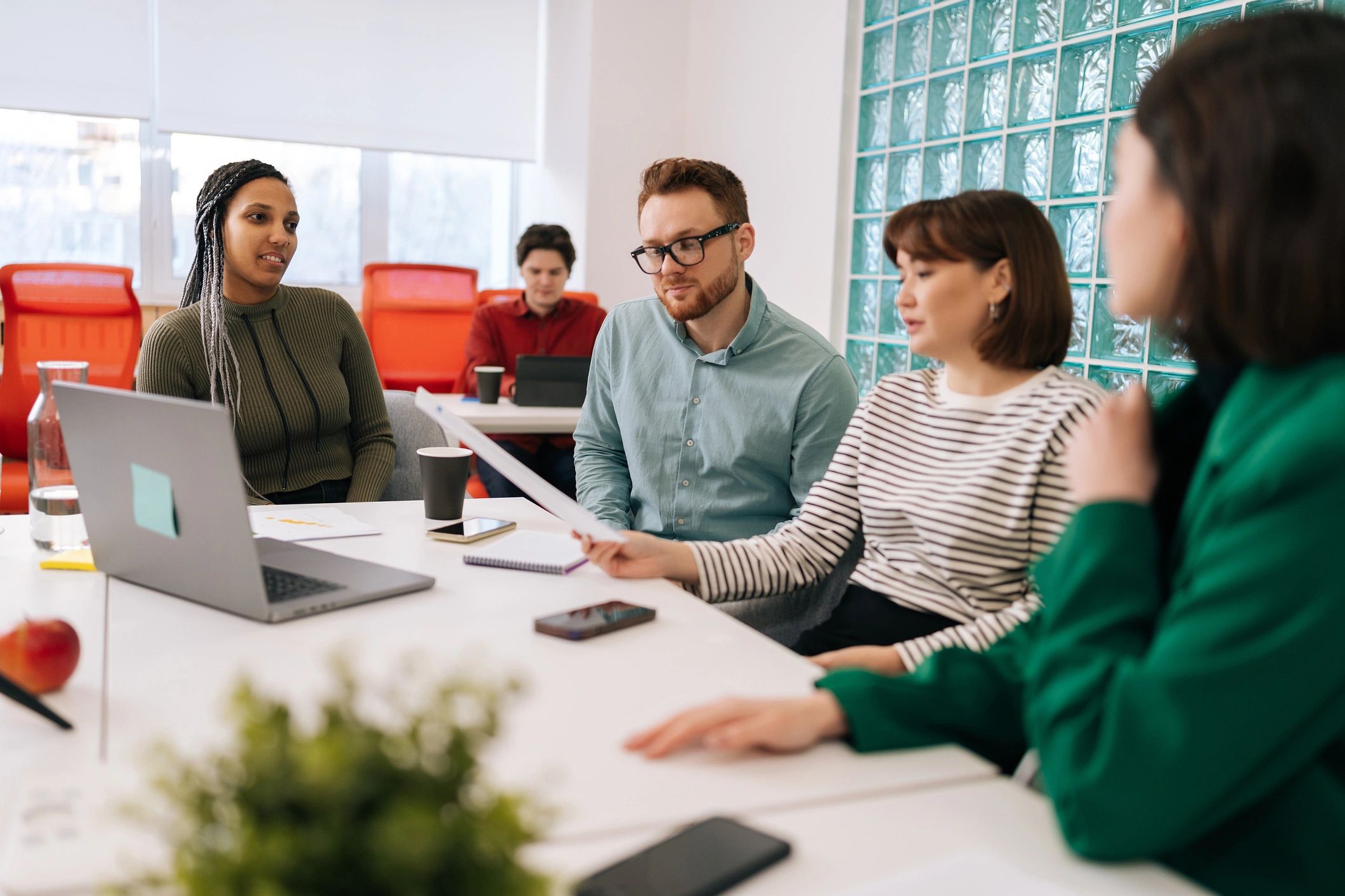 Startup team discussing reports and planning growth