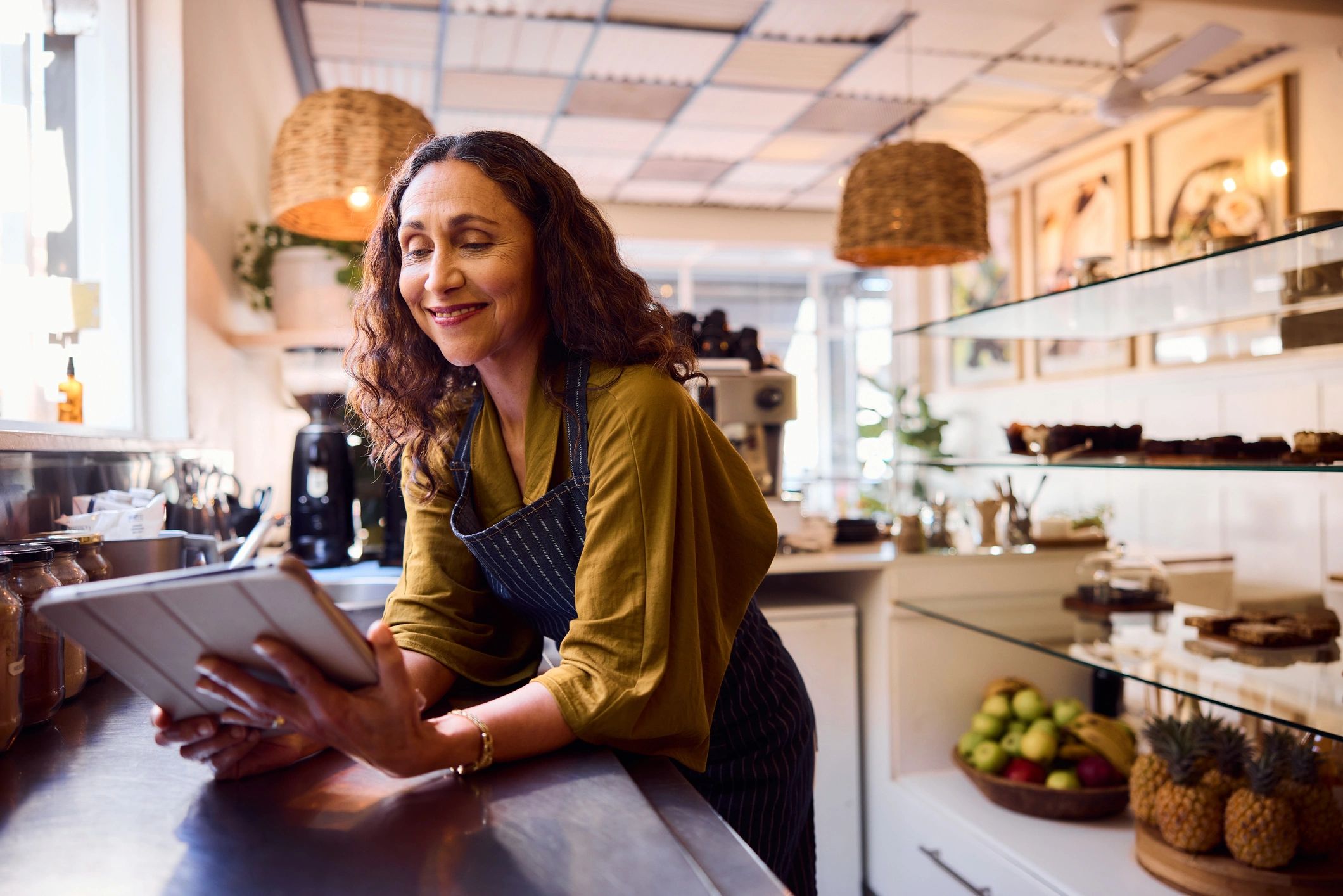 Restaurant owner using a digital tablet at the counter