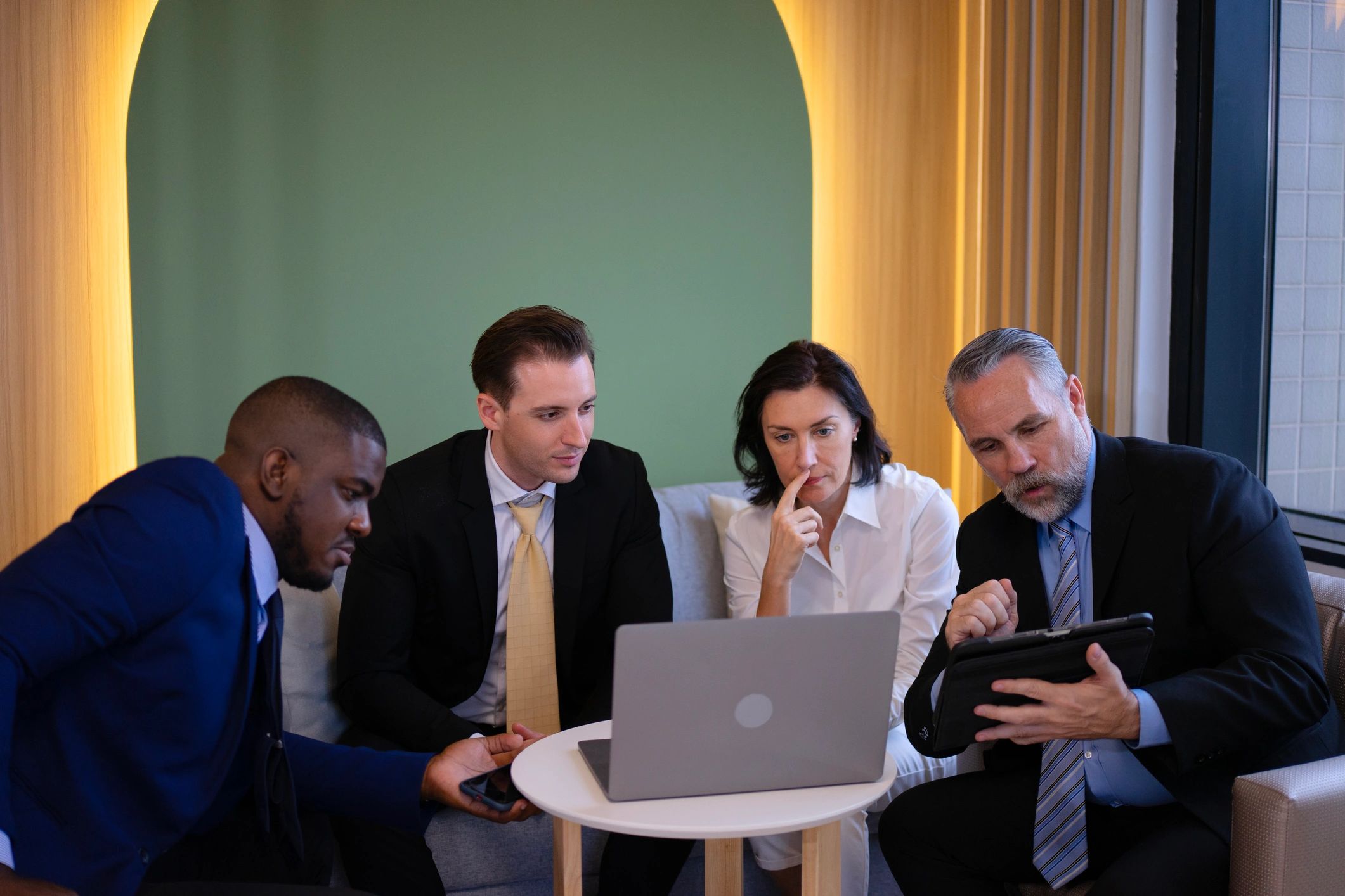 Office team meeting around workplace technology