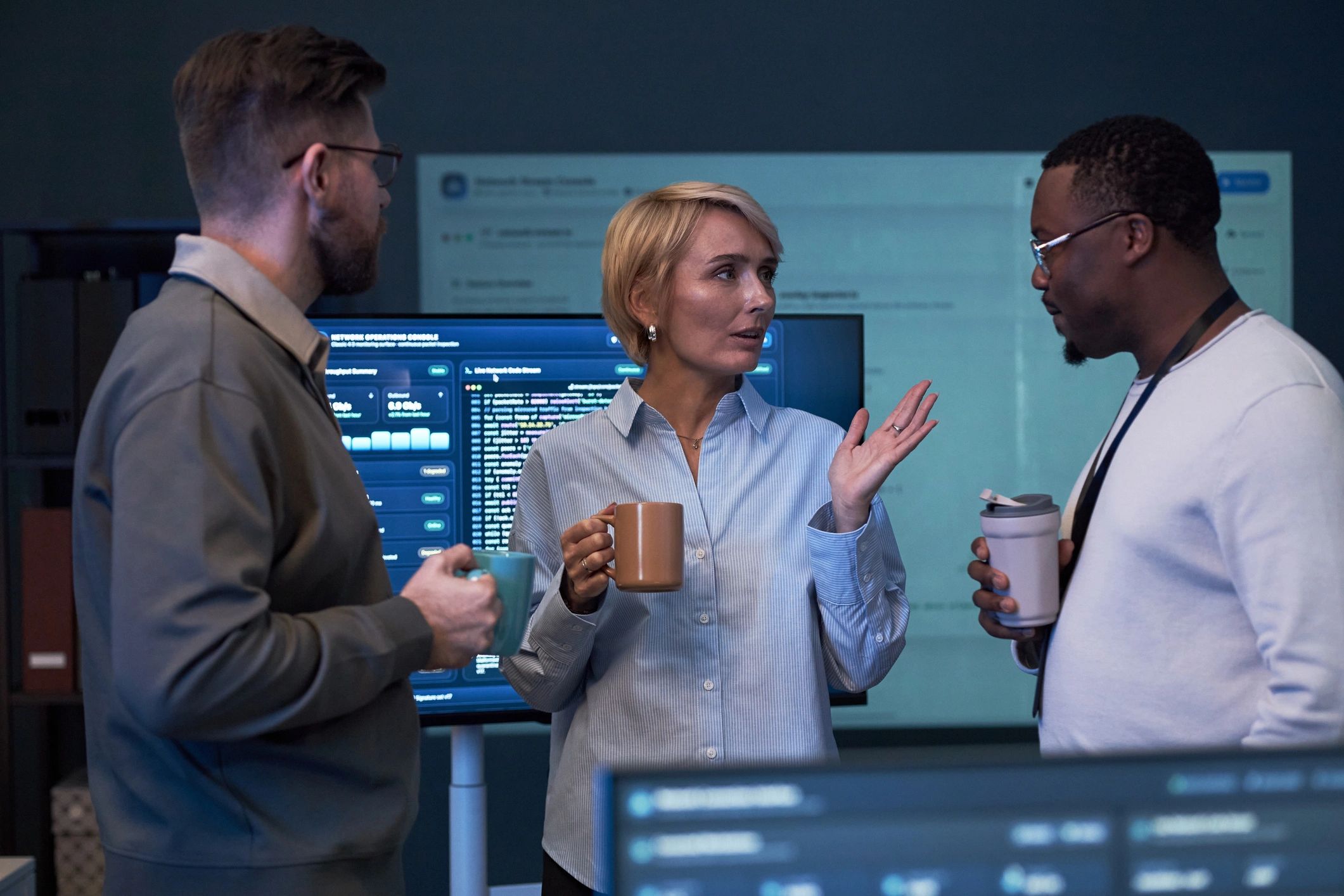 Business team discussing data strategy near digital screens